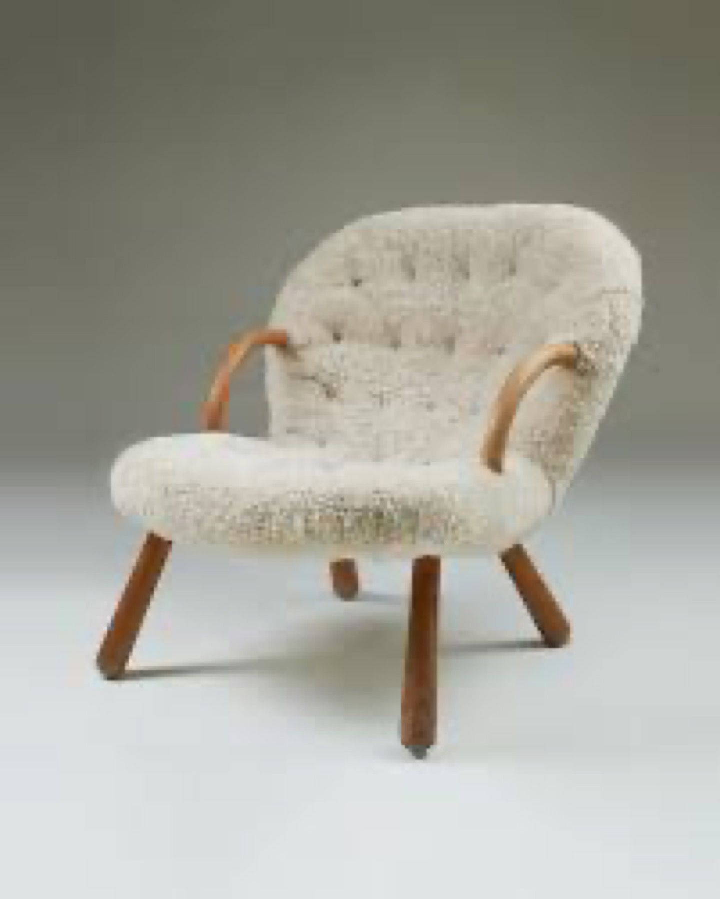 Vintage clam chair reupholstered in cream textured fabric by a London upholstery workshop