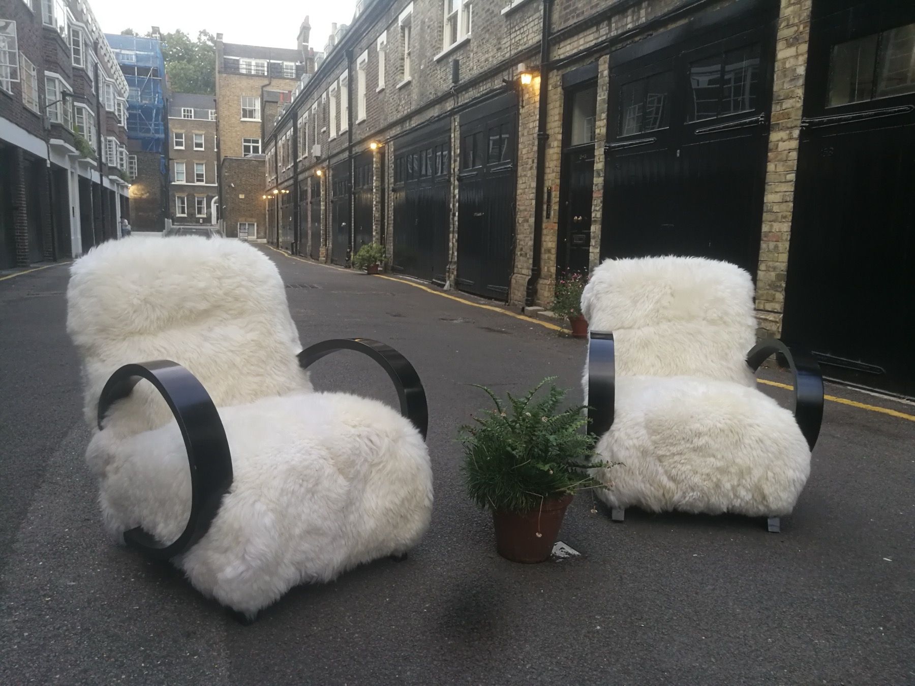 Pair of white sheepskin lounge chairs restored by Kennington Upholstery