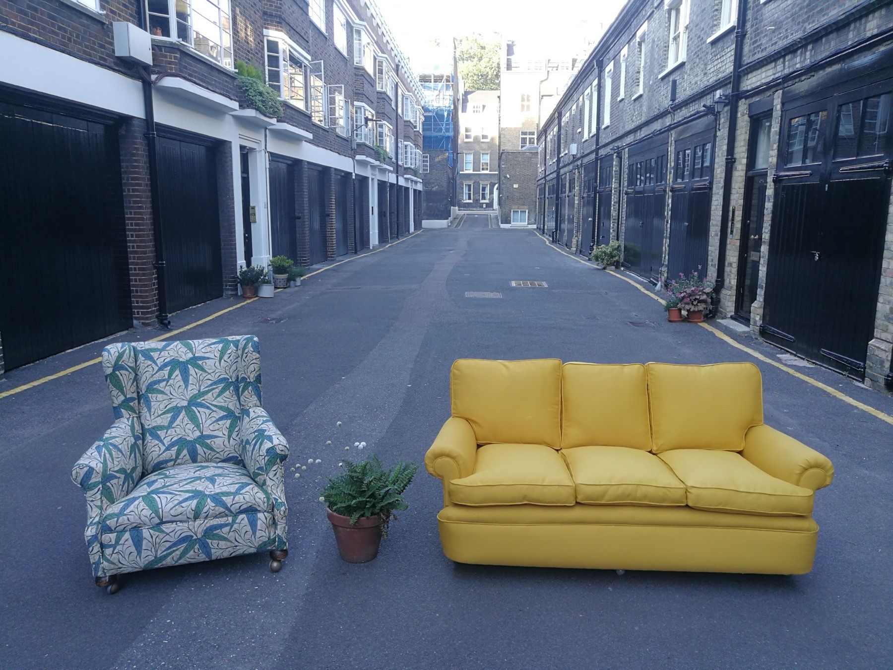 Yellow sofa and patterned armchair showing custom fabric upholstery choices