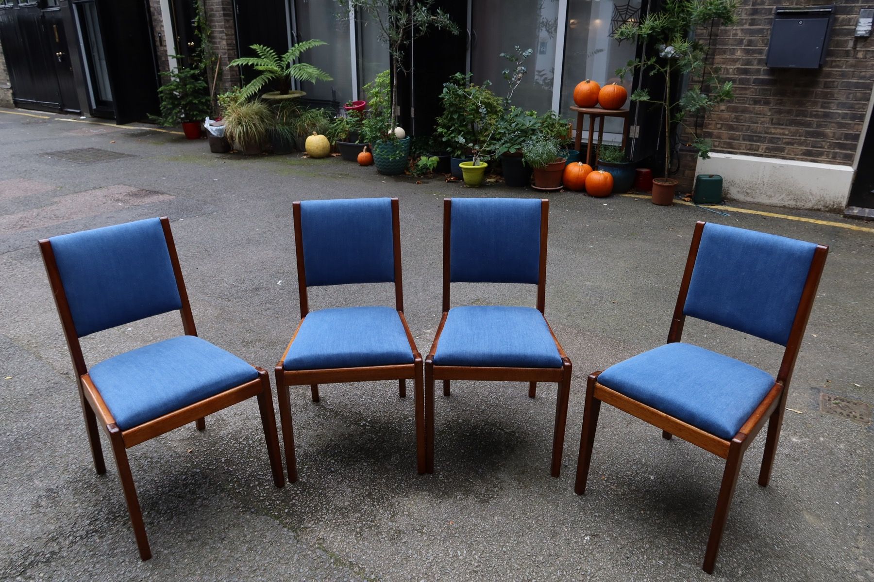 Set of wooden dining chairs reupholstered in blue fabric by Kennington Upholstery