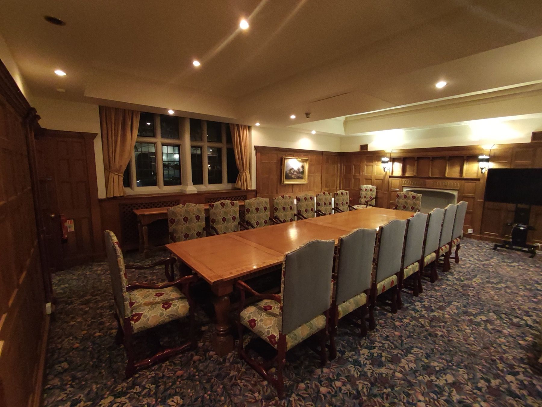 Buttoned curved banquette seating around a restaurant table with glasses set for service