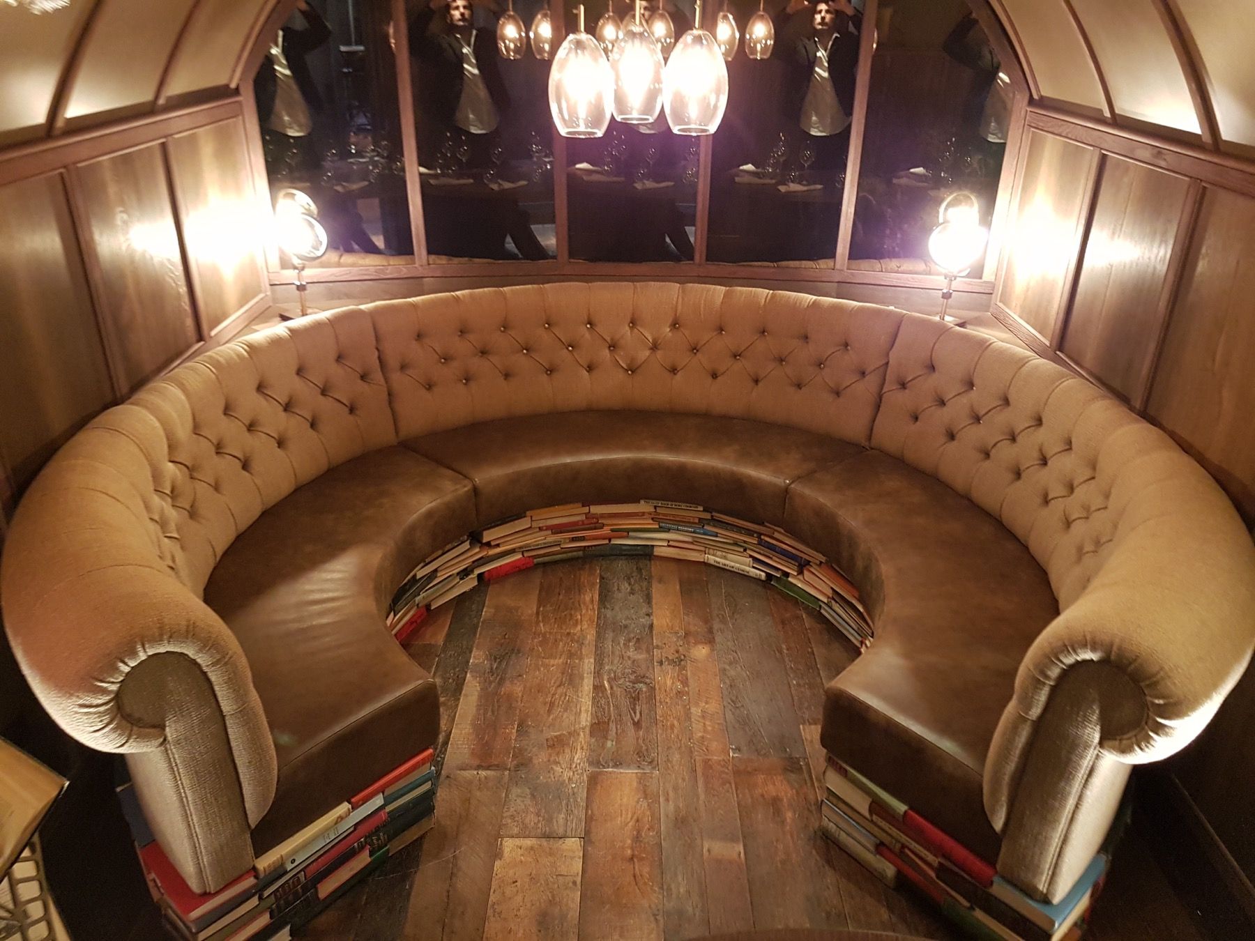 Curved buttoned restaurant banquette seating upholstered for a London hospitality interior