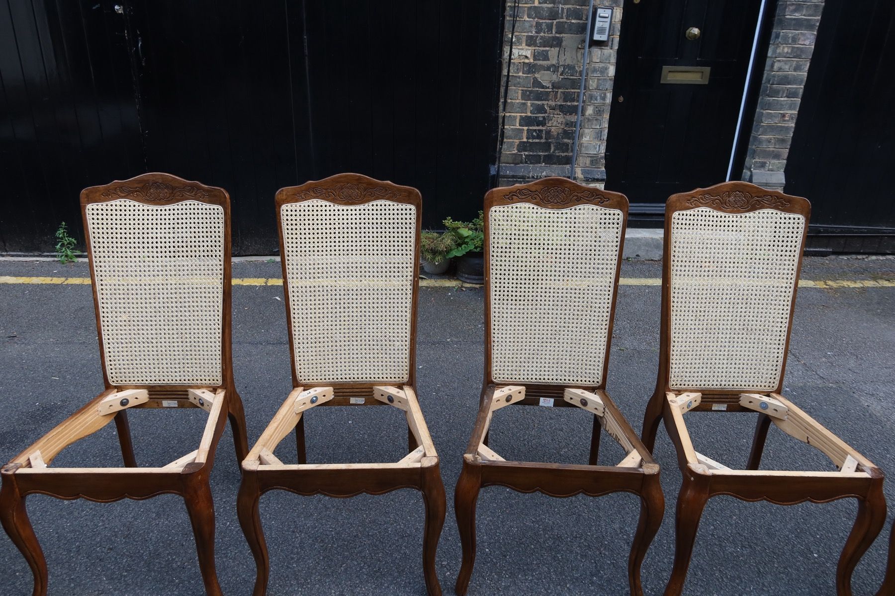 Set of cane dining chair frames repaired before seat upholstery