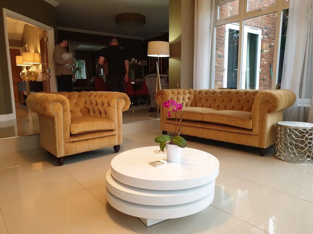 Leather Chesterfield sofa set showing deep buttoning and rolled arms