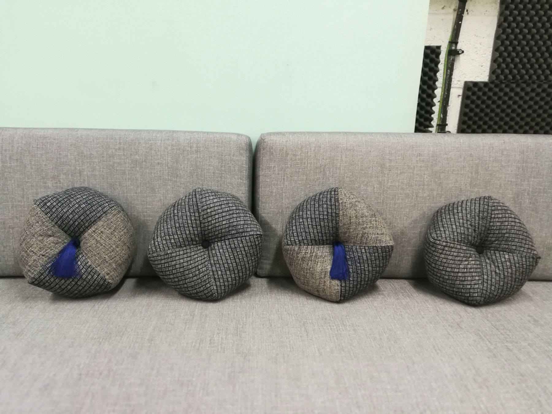 Custom scatter cushions arranged on a sofa in the upholstery workshop