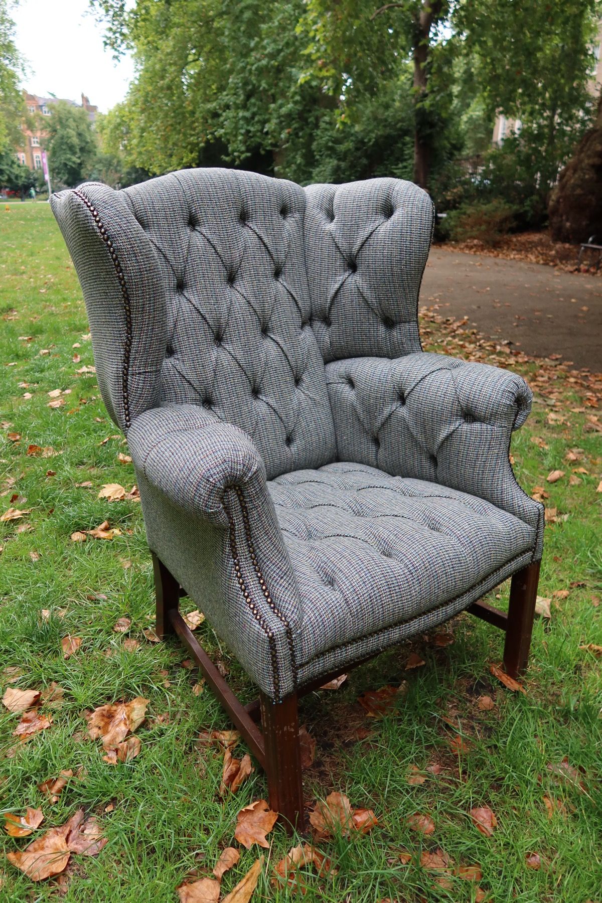 Grey checked armchair with buttoned upholstery and nailhead trim