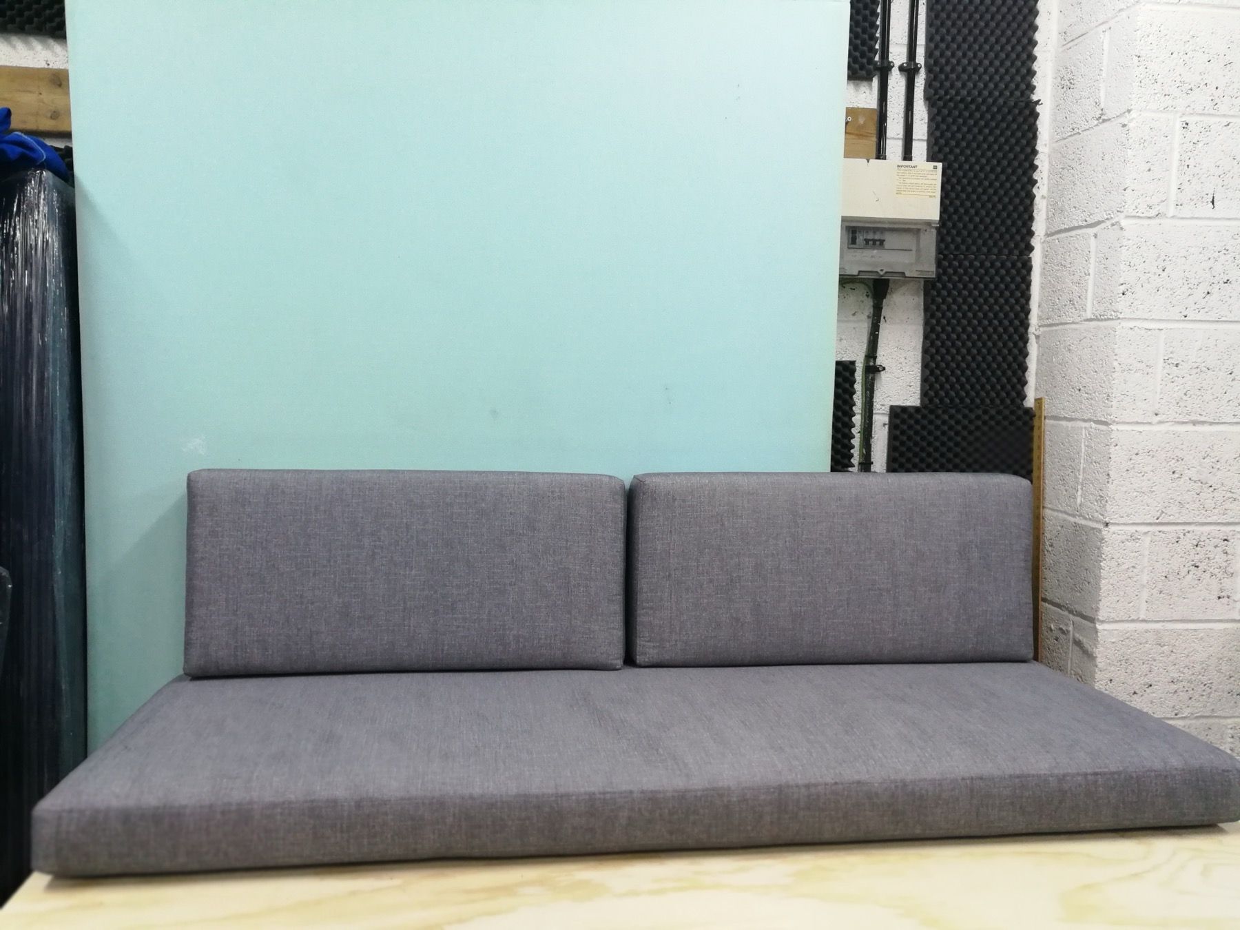 Grey woven upholstery fabric on a finished seat cushion