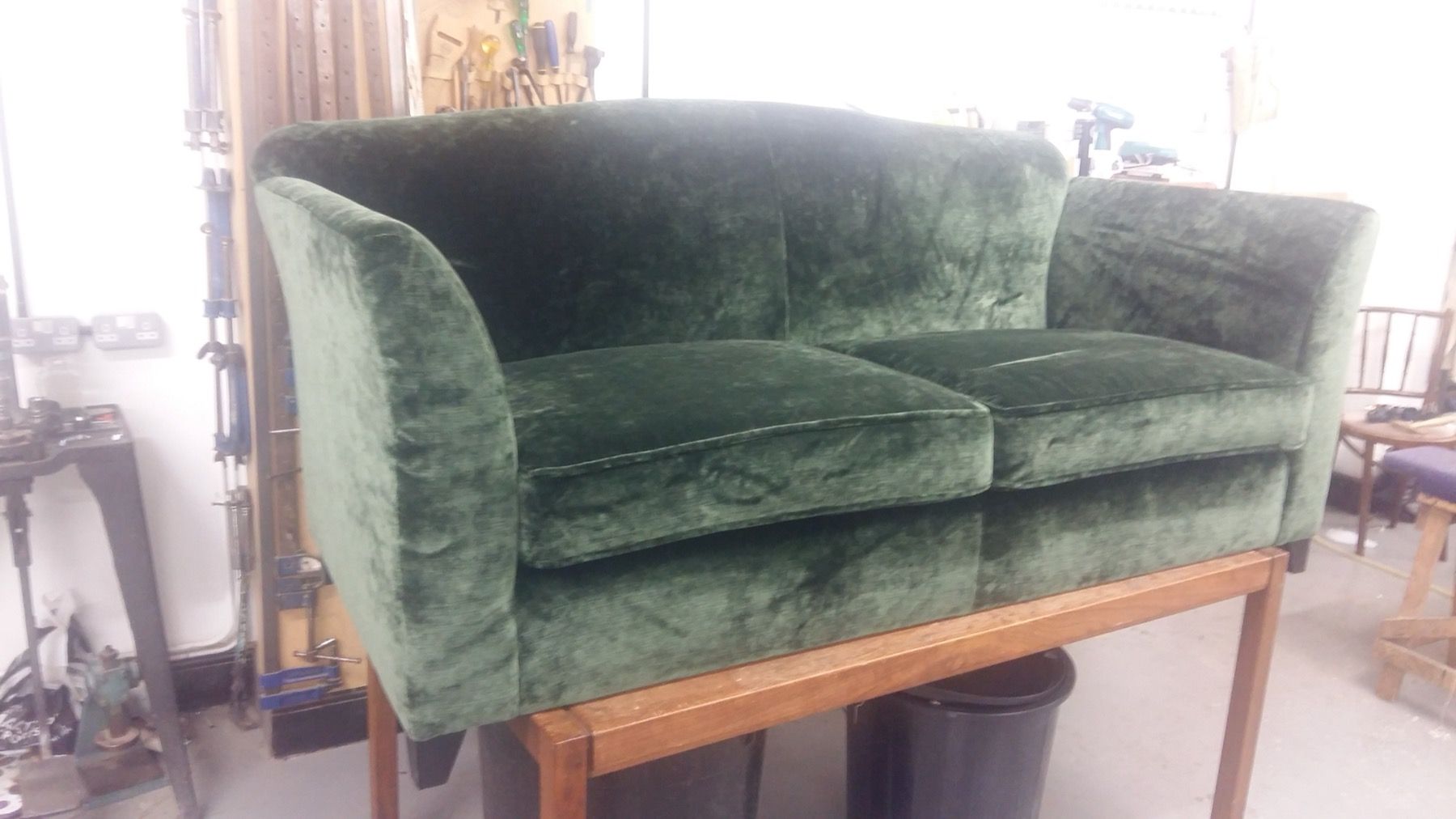 Green sofa reupholstered in a textured fabric
