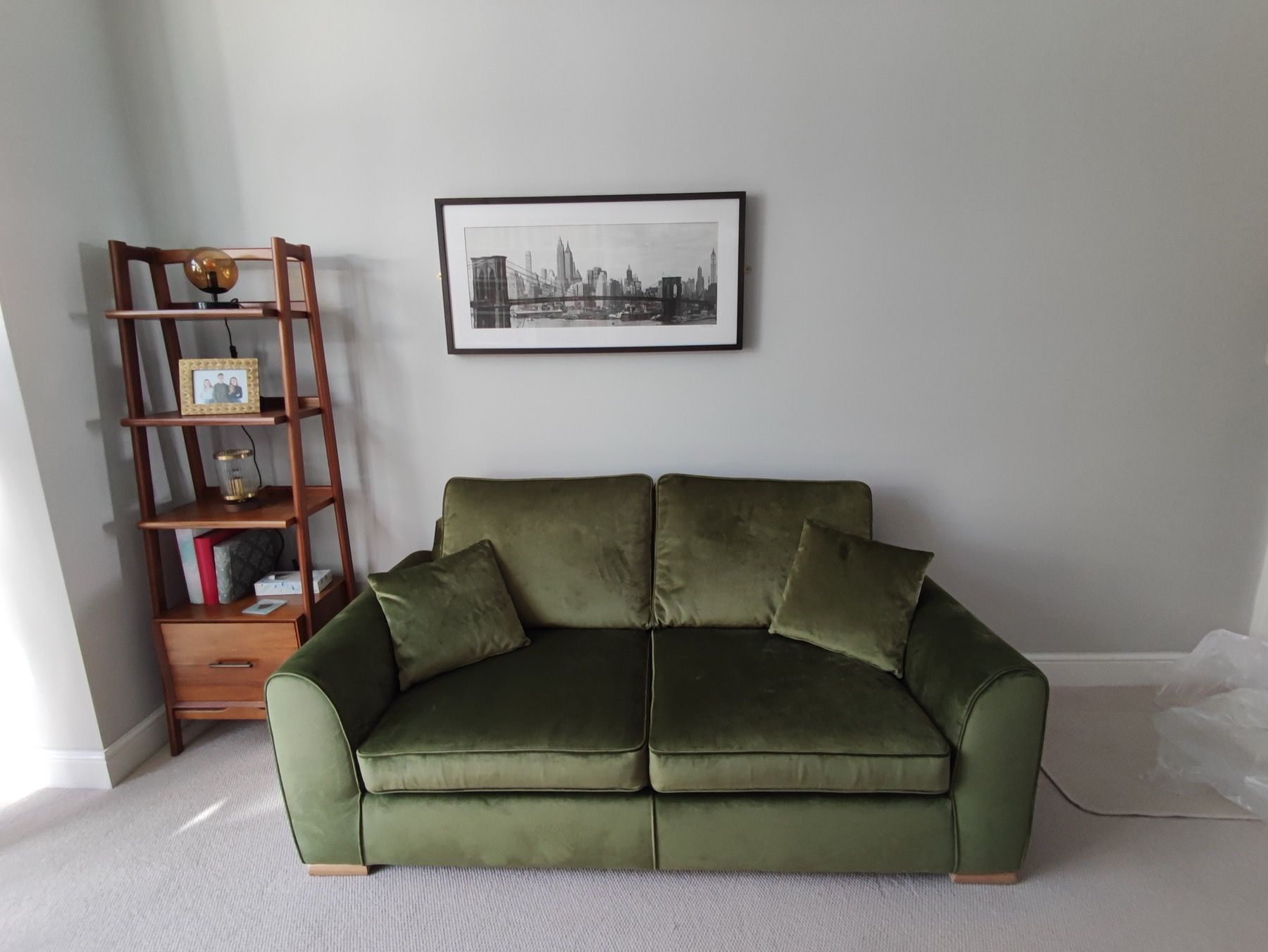 Green velvet sofa reupholstered for a London home