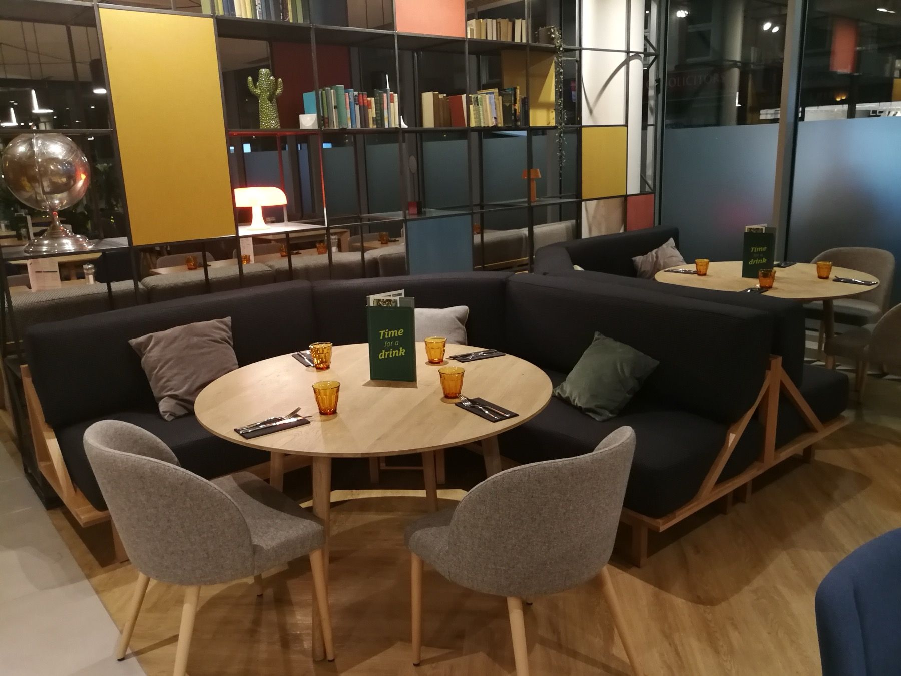 Hotel cafe seating with upholstered benches and dining chairs in a commercial interior