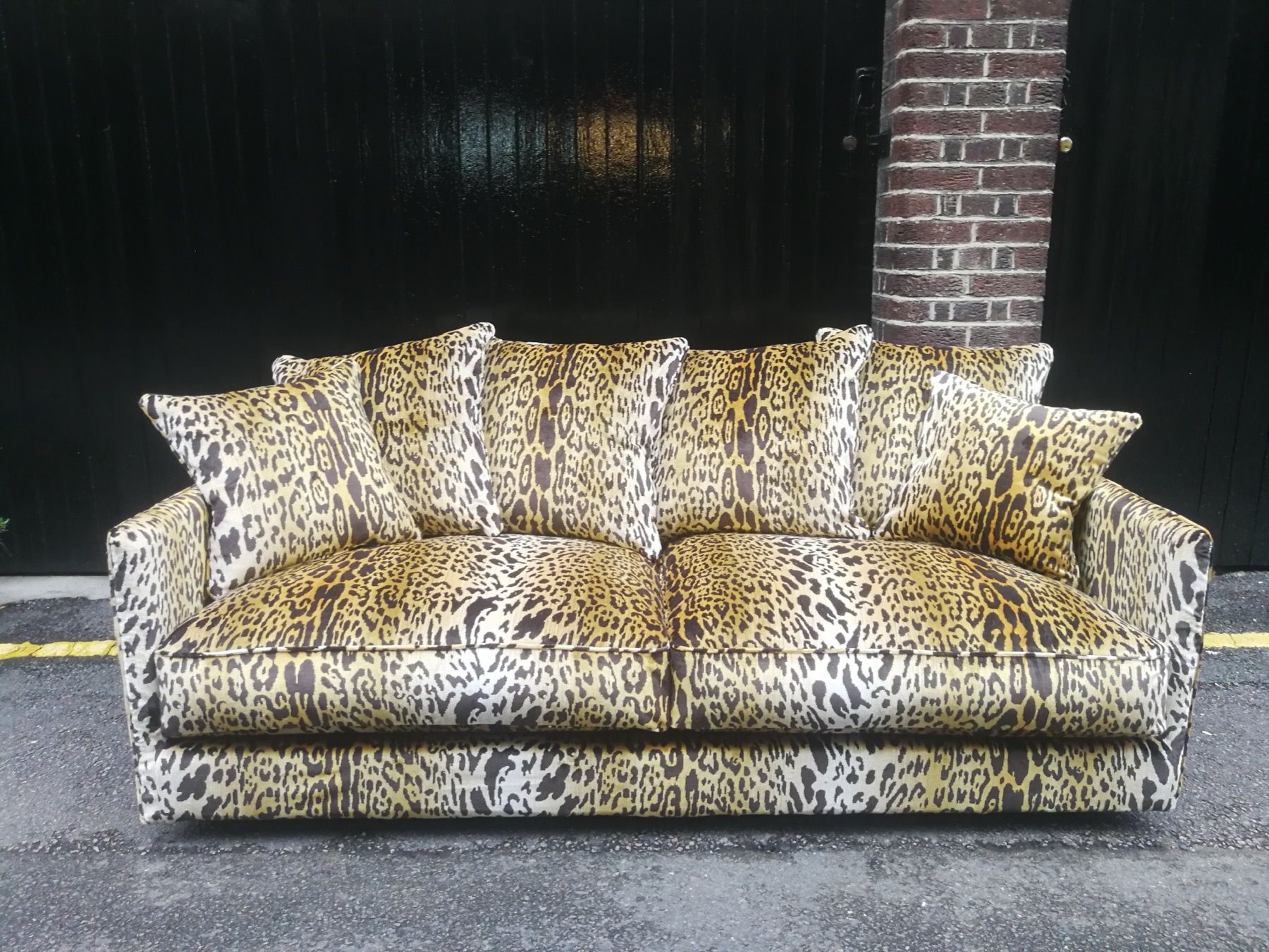 Sofa reupholstered in a bold leopard print fabric outside a London workshop
