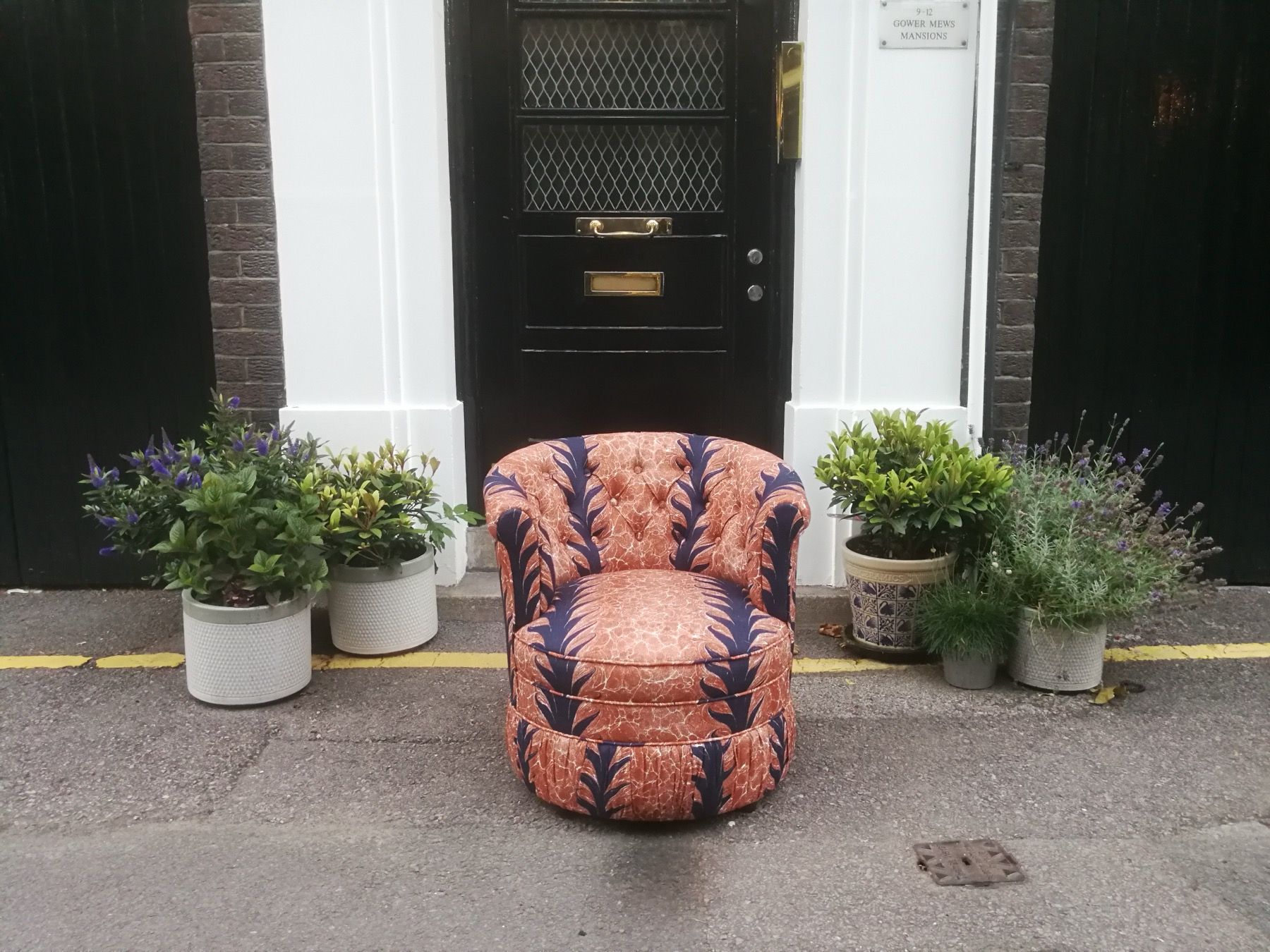 Patterned fabric tub chair reupholstered with a bold decorative print
