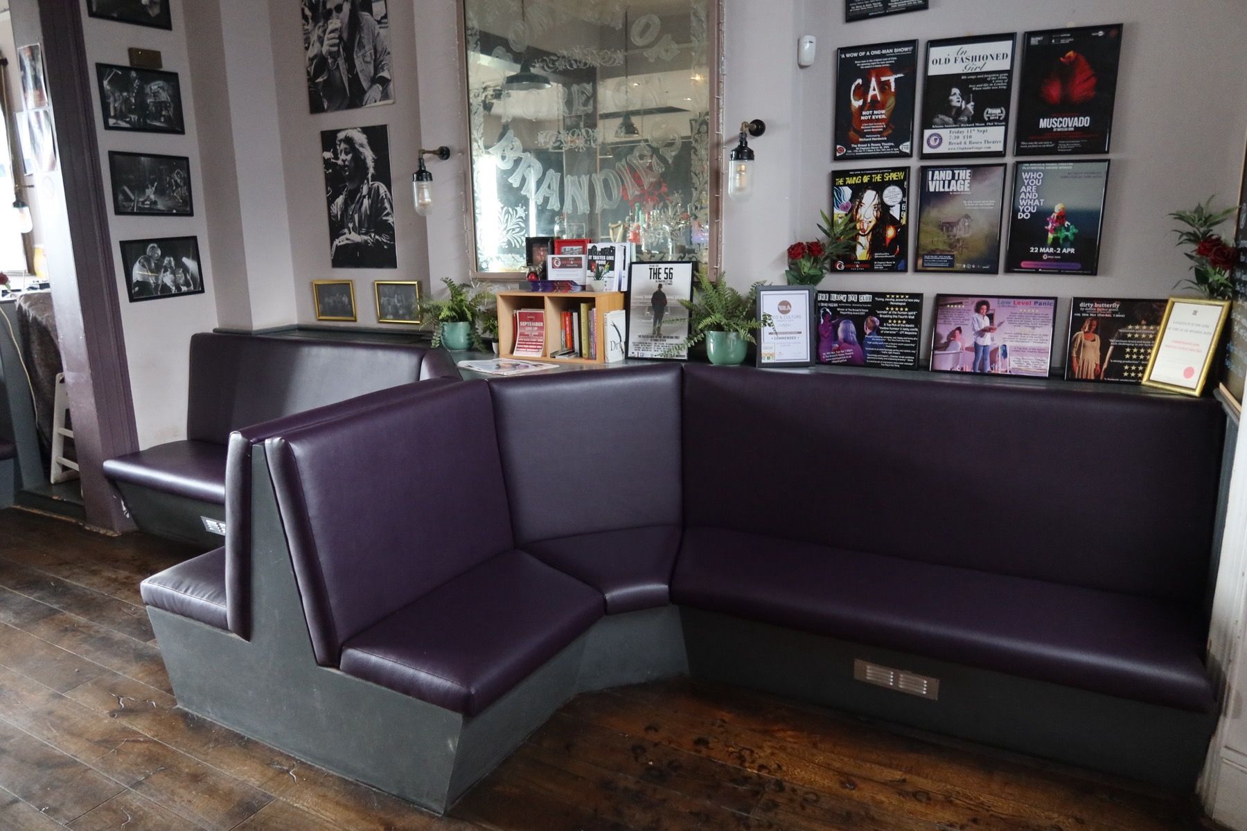 Purple upholstered pub corner seating in a London venue