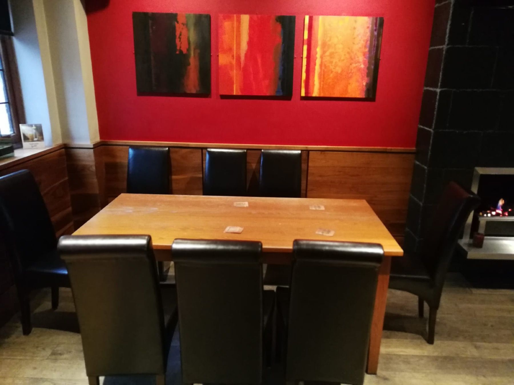 Pub dining chairs and bench seating arranged around a wooden table