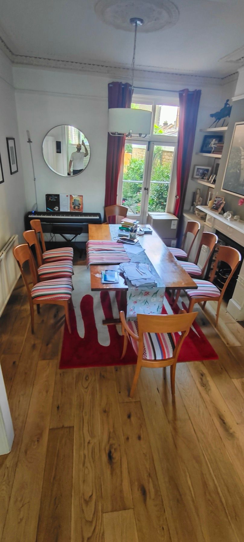 Striped dining chairs reupholstered and fitted around a London dining table