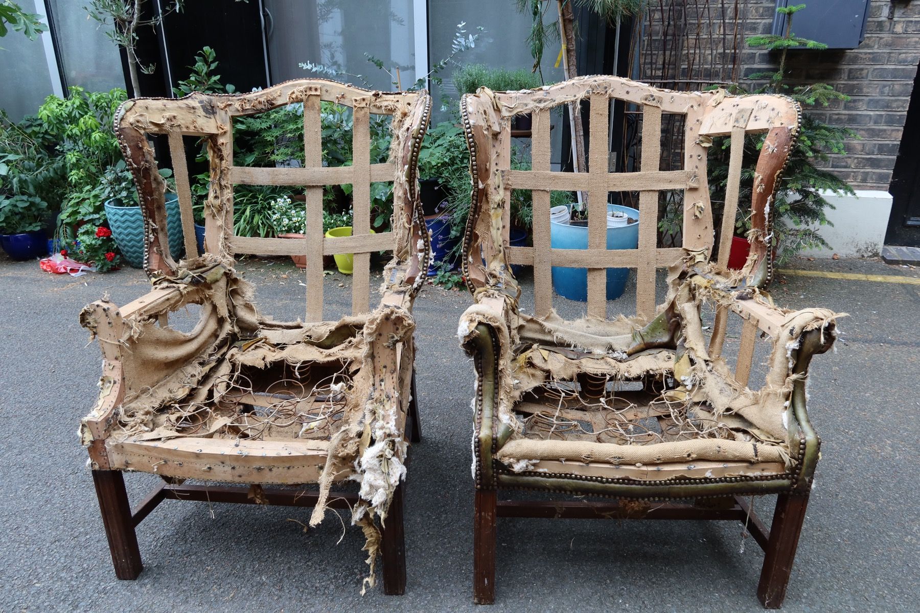 Two antique chairs stripped back to webbing and springs before reupholstery in London